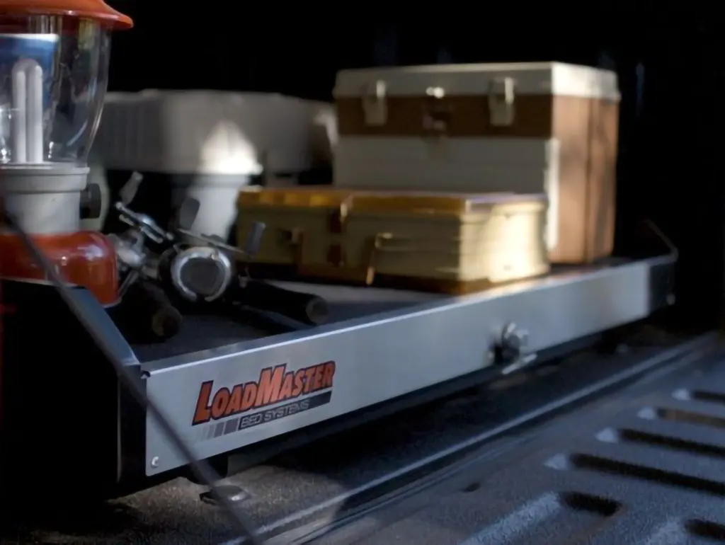 LoadMaster bed system in a truck bed holding camping gear and storage boxes, from Canyon State.