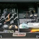 Cap-Pack storage system from Canyon State, holding rifles, binoculars, and gear in a truck bed.