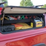 Tool storage compartment from Canyon State, packed with tools, cables, and a battery charger.
