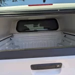 Interior view of a white Ranch Echo camper shell on a truck at Canyon State RV.