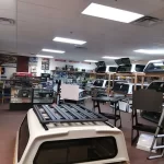 Interior of Canyon State RV showcasing various camper shells and truck accessories on display.