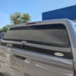 Close-up of a gray Chevrolet Silverado with a Ranch Fusion camper shell from Canyon State RV.