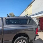 Gray Ram Sport truck with a Ranch Fusion cap, parked outside Canyon State RV.