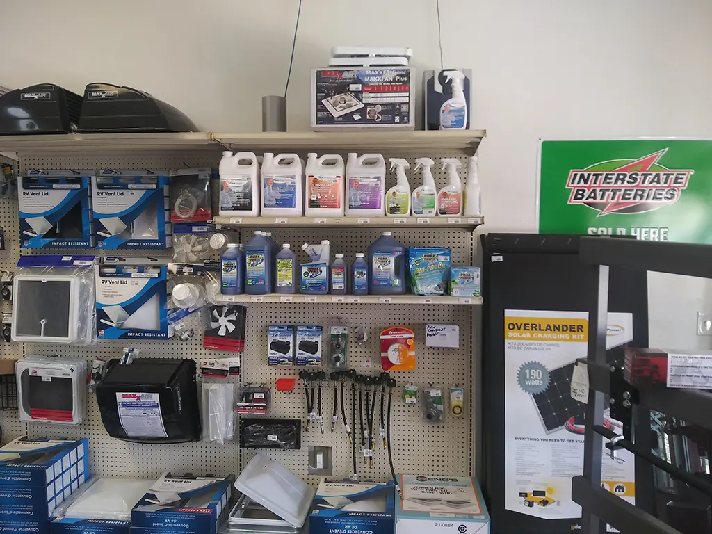 Shelves of RV and truck accessories, including vent lids, cleaners, and batteries, at Canyon State.