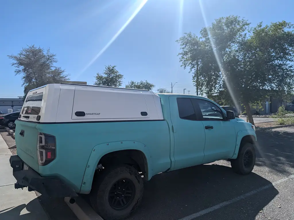 Light blue truck with an RSI SmartCap parked outdoors.